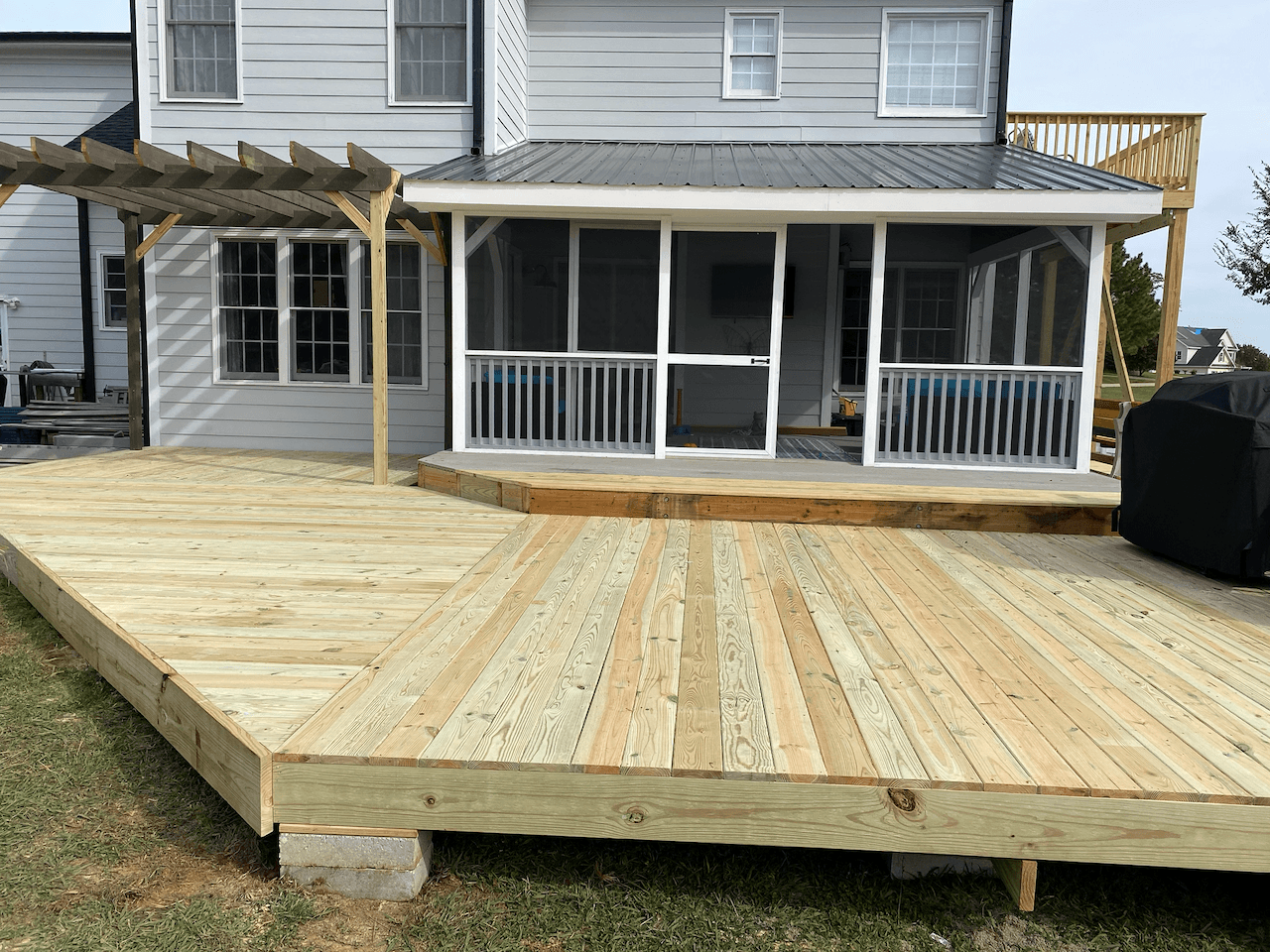 New wood deck with pergola and screened porch