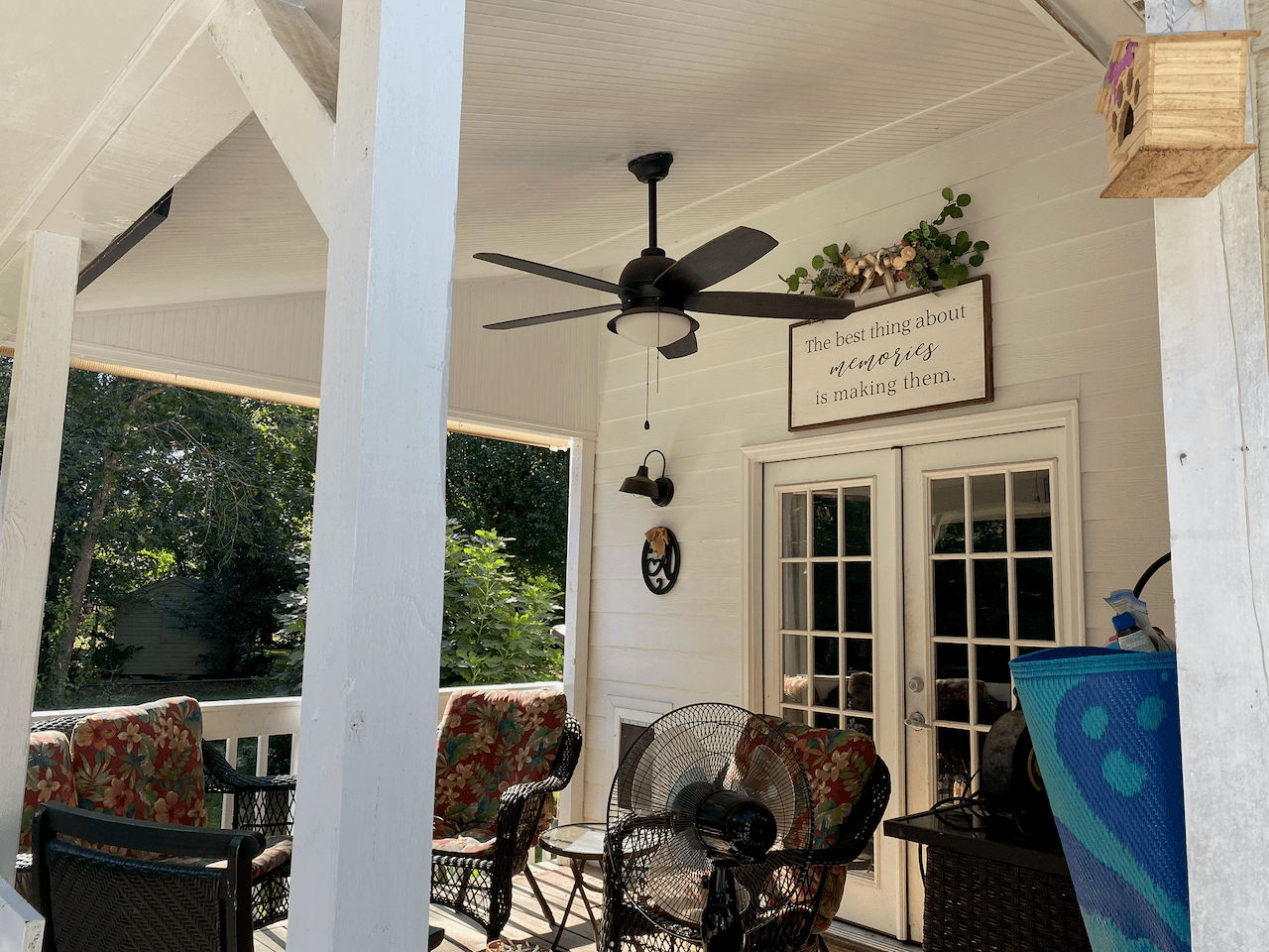 Covered porch with ceiling fan, wicker seating and French doors